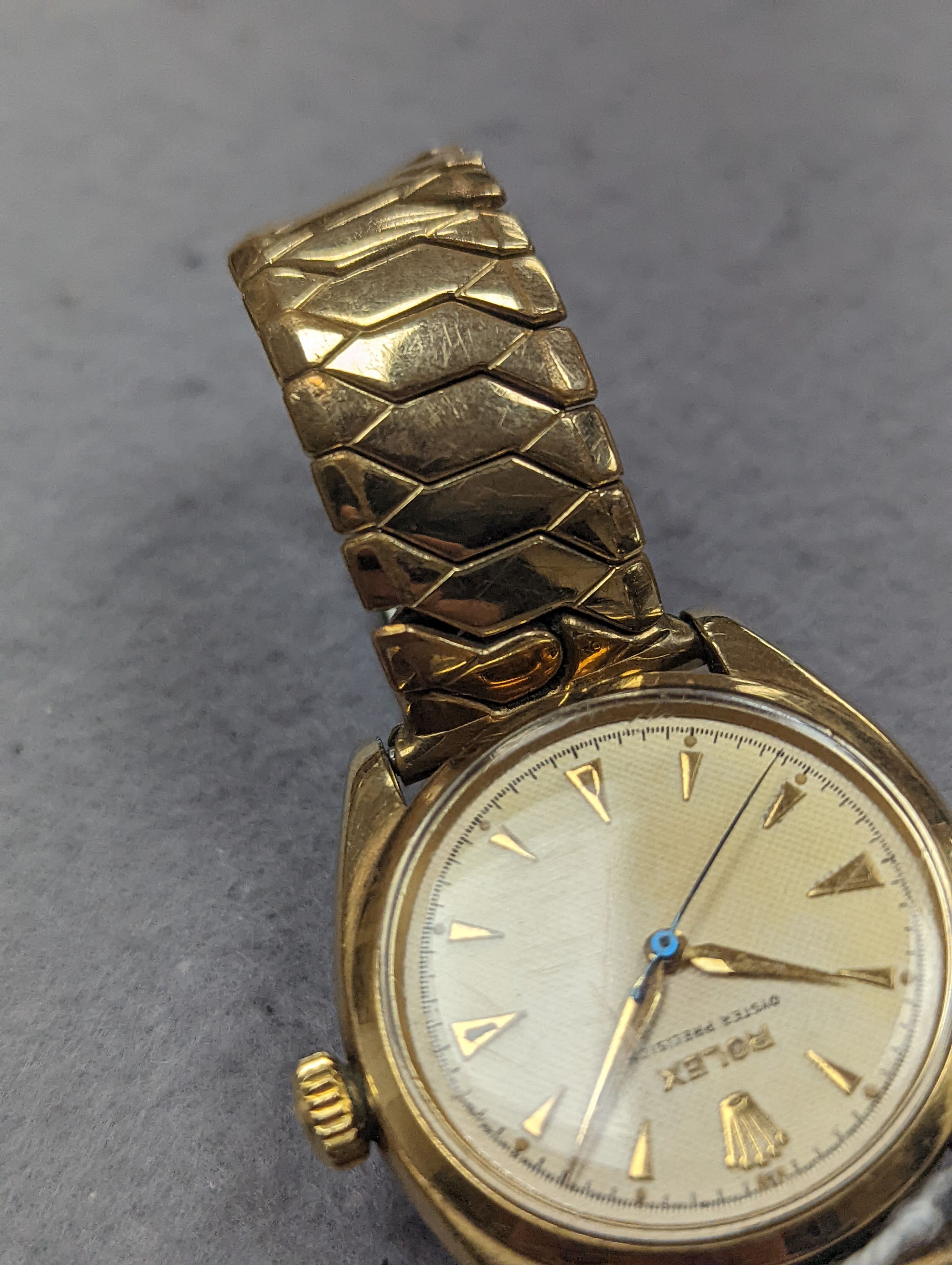 A gentleman's 1950's 9ct gold Rolex Oyster Precision manual wind wrist watch, with honeycomb dial and baton numerals, on associated expanding bracelet, case diameter 35mm, with personalised inscription to case back, no b